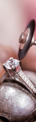 Jeweler polishing the diamond ring. Jeweler polishing the diamond ring.