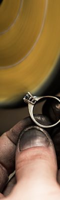istockphoto-519161770-170667a Jeweler is polishing a diamond ring with polishing machine.Speedlight was used for this image.
